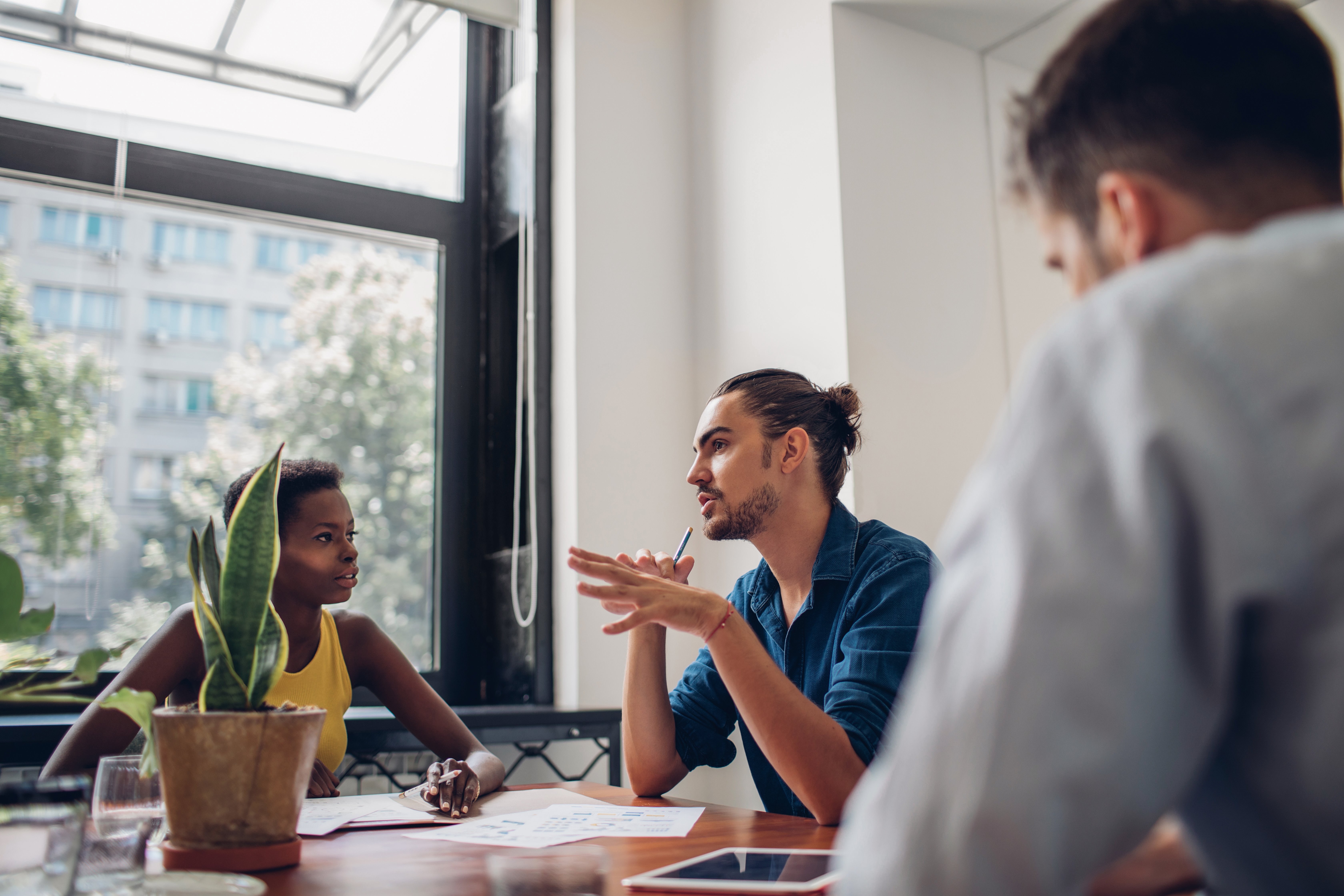 employees talking to one another at table